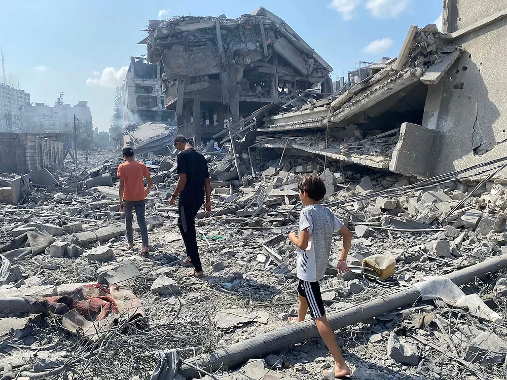 Palestinians inspect damage after an Israeli airstrike on the El-Remal area of Gaza City, 9 October 2023.