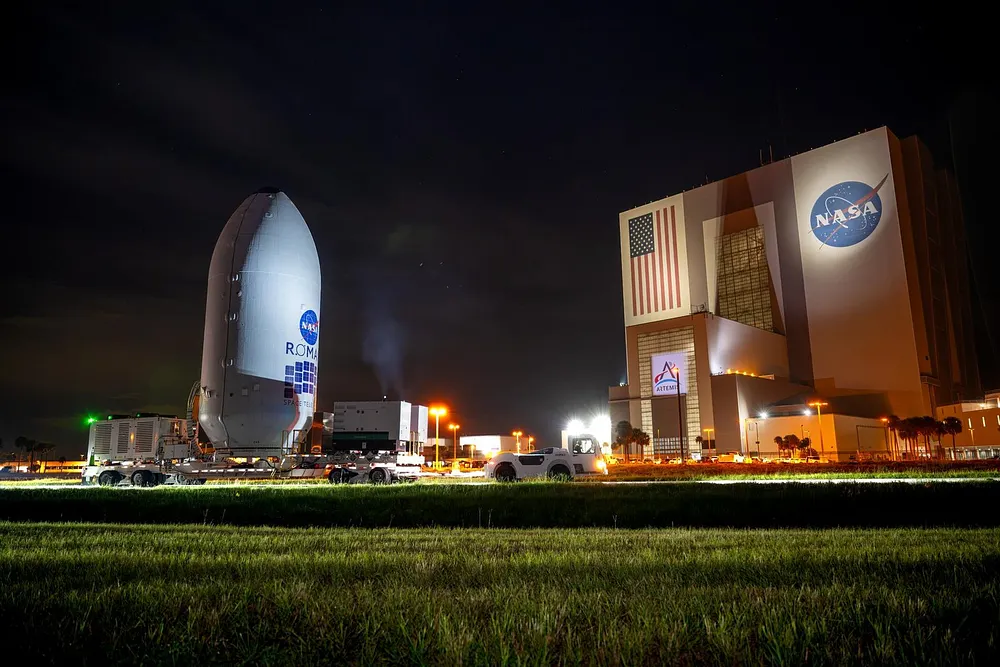 NASA's Nancy Grace Roman Space Telescope, encapsulated in its payload fairing, travels from the Payload Hazardous Servicing Facility to the SpaceX hangar at Launch Complex 39A, Kennedy Space Center, 25 August 2026.