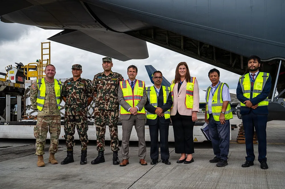 U.S. and Nepali officials beside relief supplies at Tribhuvan International Airport, Kathmandu, Nepal, 2 September 2026.