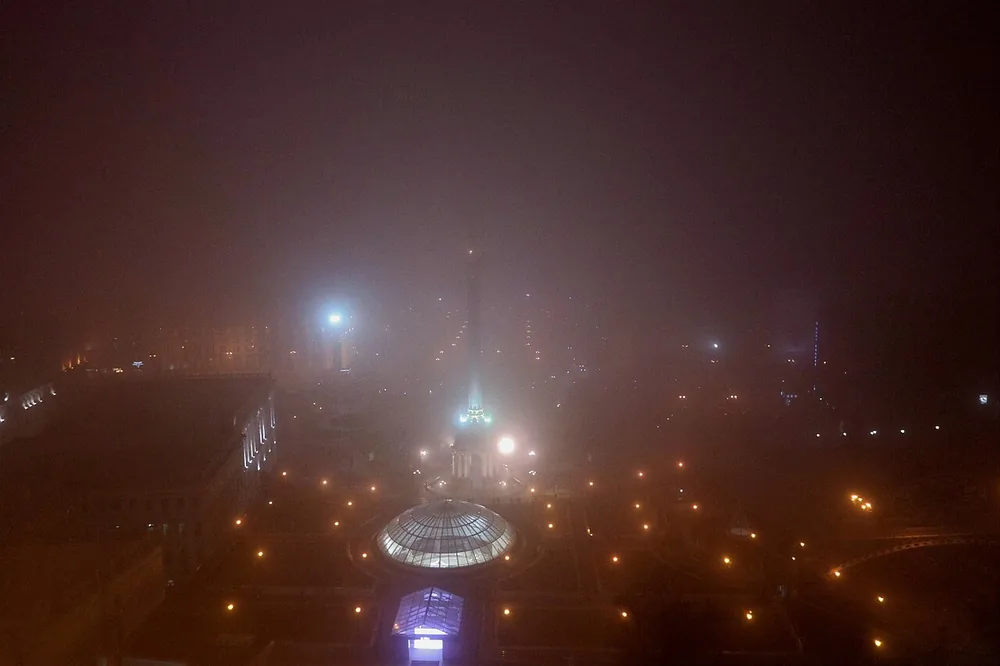 Maidan Square in Kyiv, Ukraine, with mist at night.