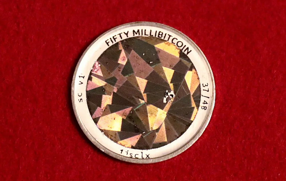 The reverse of a 0.05 BTC Serp physical bitcoin coin, photographed by Gage Skidmore.