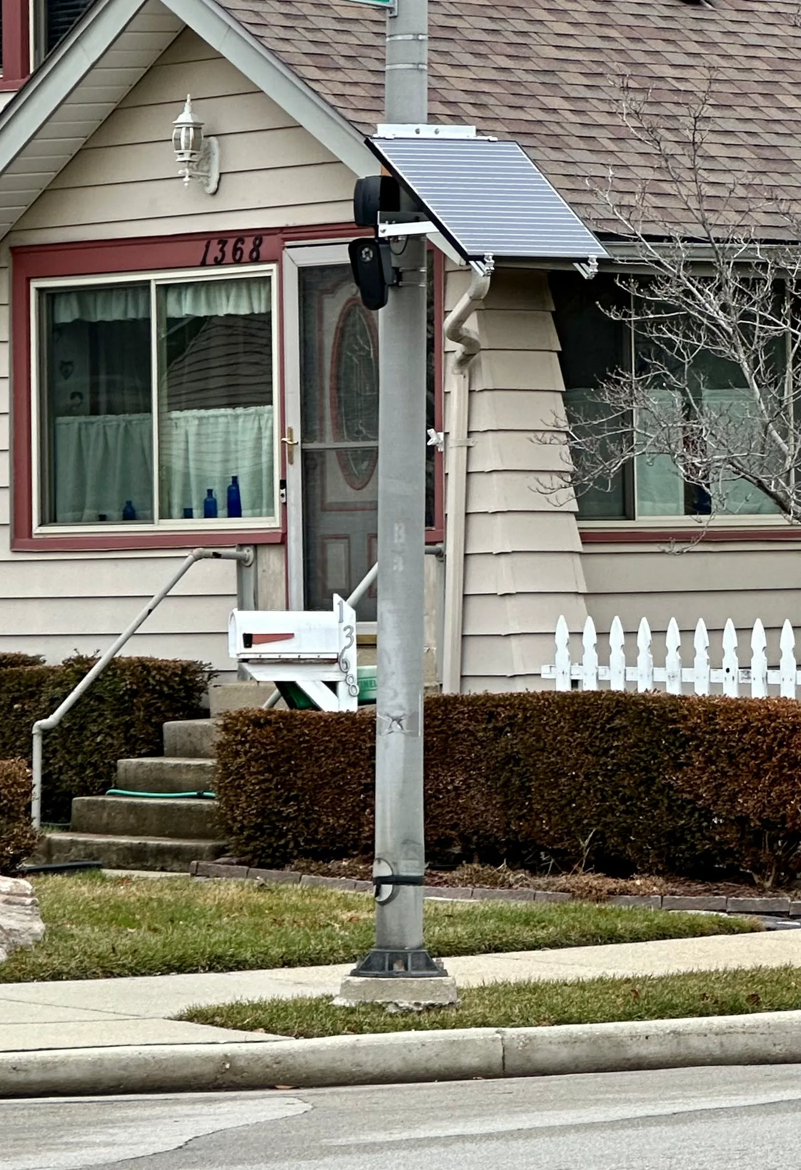 A Flock Safety licence-plate camera with a solar panel on a light pole, December 2023.